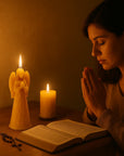 woman praying with guardian angel beeswax candle.