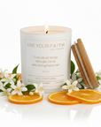 Candle with Phil. 4:13 message on a white background with orange slices and flowers.