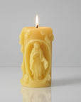 Beeswax Yellow candle with a figurine of Virgin Mary design on white background