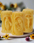 Set of three beeswax candles with images of the Holy Family, Virgin Mary and Jesus on the Cross