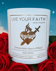 Candle with 'Live Your Faith' label surrounded by red roses against a starry night sky Immaculate heart of Mary Candle