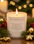 Candle with 'Live Your Faith' text and wooden lid on a white background with the bible quote John 1:14