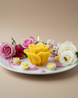beeswax rosette candle with flowers on a white plate