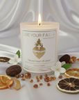 Candle with 'Live Your Faith' label surrounded by decorative elements on a white background