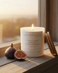 Catholic Prayer Candle with the Surrender Novena Prayer, fig scent, on a wooden window mill surface with figs
