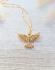 cubic zirconia dove necklace on a white surface