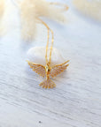 holy spirit necklace on neutral table