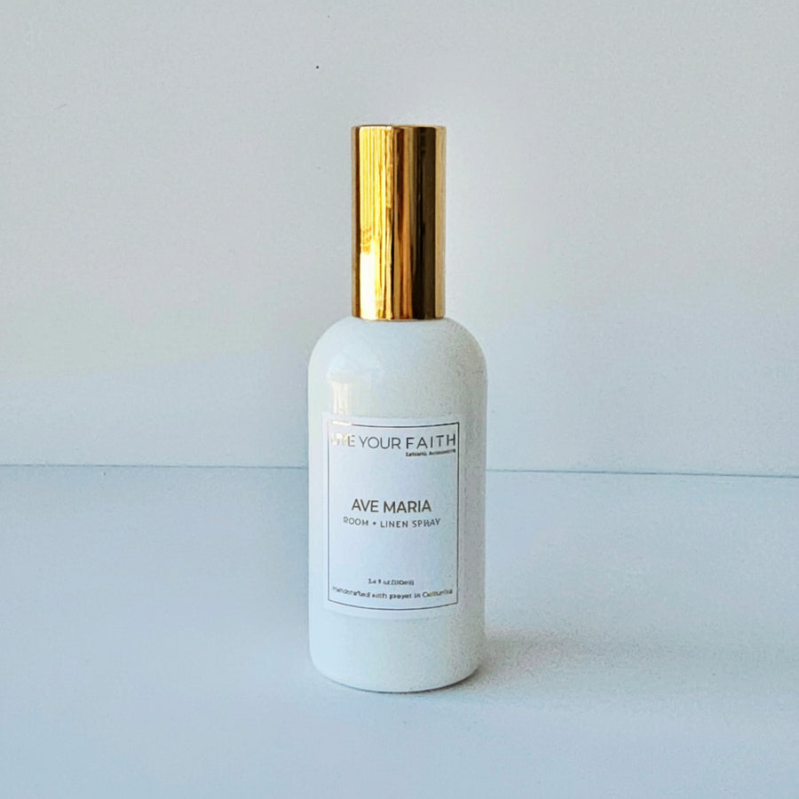 White bottle with gold cap on a light gray background