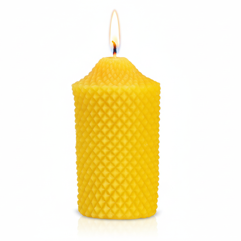 Yellow pure beeswax textured candle on a white background with a flame