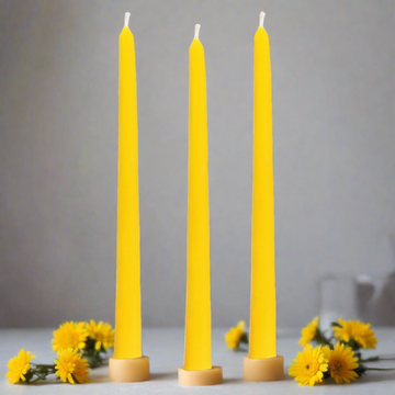 set of three beeswax pillar candles with yellow flowers.