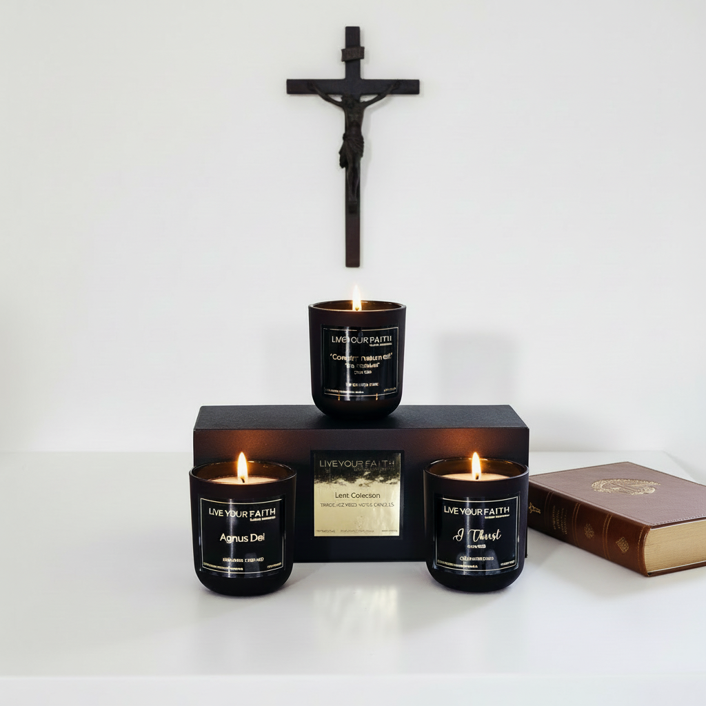 Three lit candles in black containers with visible labels on a white background a bible and a crucifix 