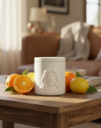 White ceramic jar with embossed face design on a coffee table