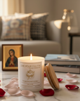 Immaculate Heart of Mary catholic prayer candle in a coffee table next to a Virgin Mary image and surrounded with rose  petals 