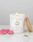 immaculate Heart of Mary Candle in a white background in rose water scent next to rose petals and  rosary