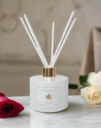 white Our Lady of Sorrows Diffuser with roses and neutral background
