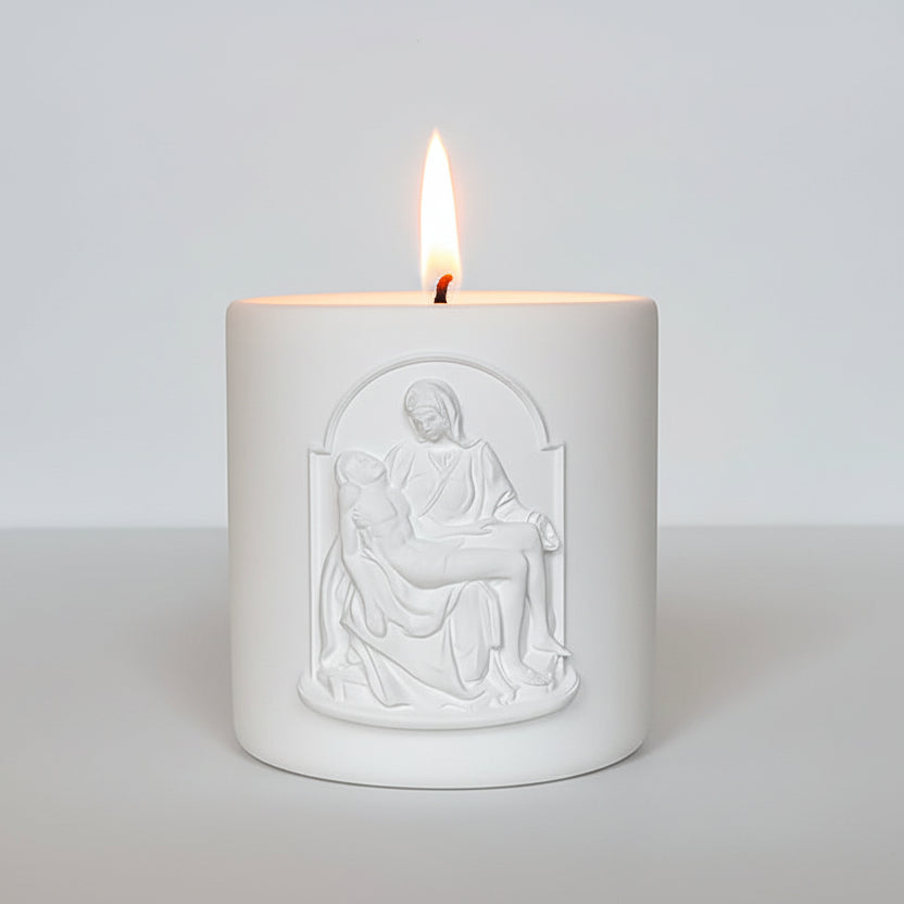 Decorative candle with Pieta image on a white background