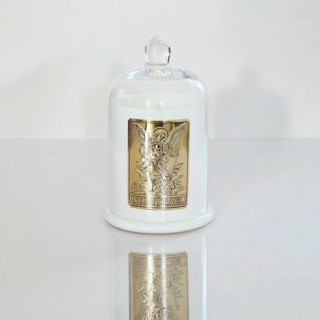 Decorative jar with a gold emblem and 'St. Michael' text under a glass dome on a white background