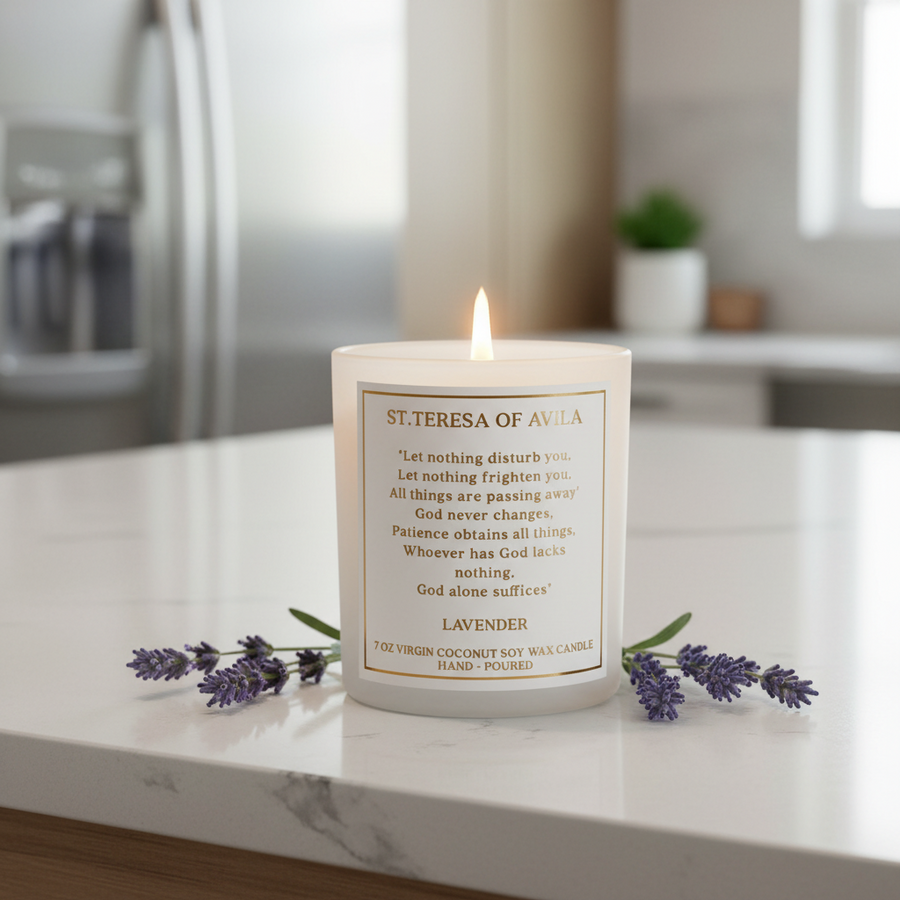 Candle with a prayer from St. Therese of Avila on a marble surface with lavender flowers