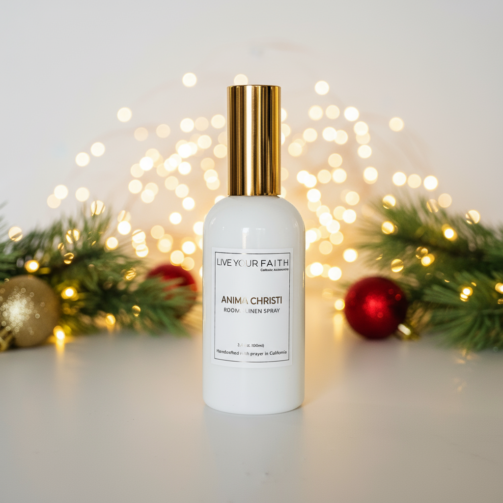 White bottle with gold cap labeled 'Live Your Faith' on a light background with festive decorations. Anima Christi room spray