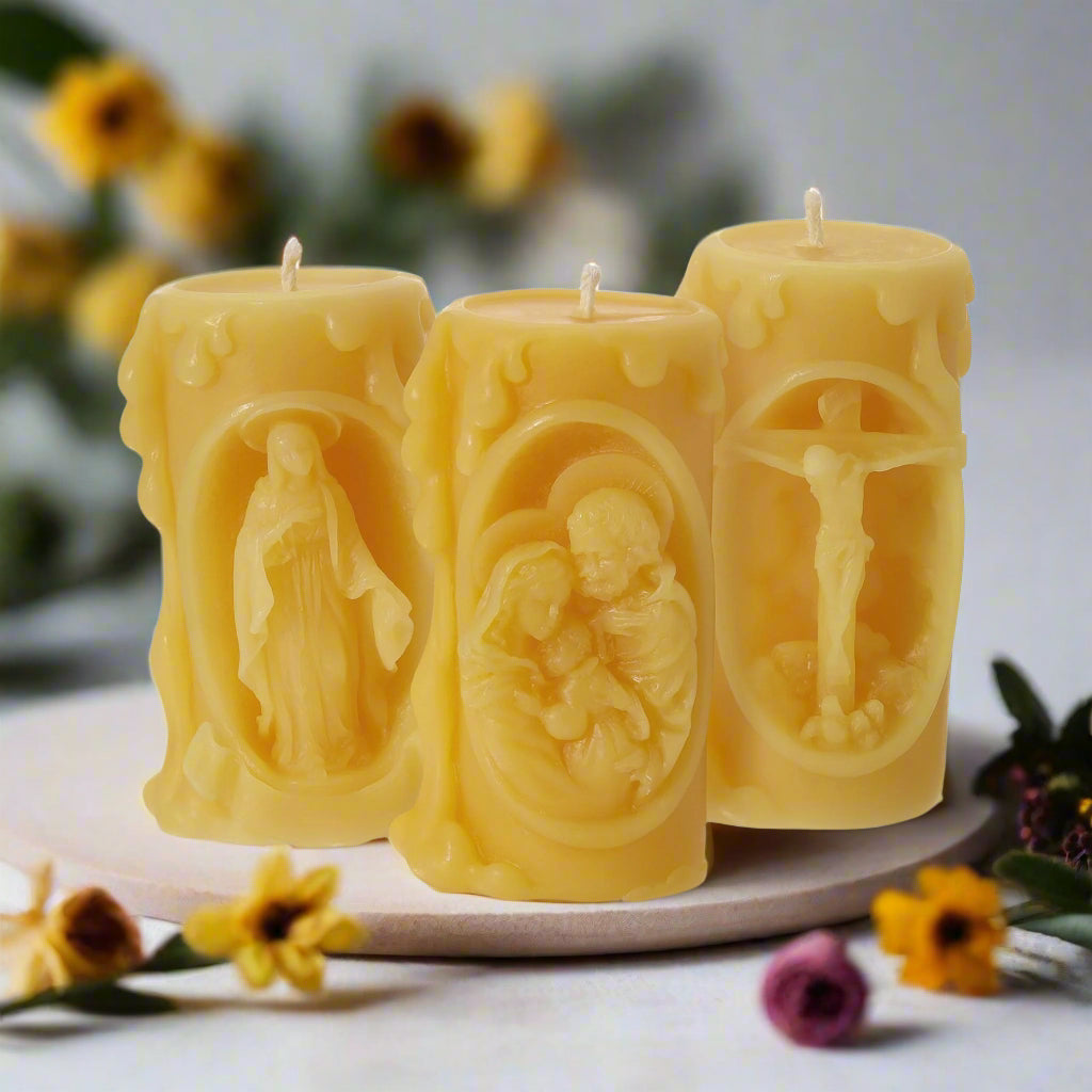 Set of three beeswax candles with images of the Holy Family, Virgin Mary and Jesus on the Cross
