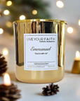 Scented prayer candle in gold vessel, 7oz. Scent is Christmas evergreen. Candle name Emmanuel, God is with us.