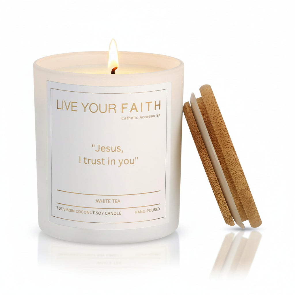 White candle with  the words "Jesus I trust in you" made by Live Your Faith Catholic on a white background with a flame