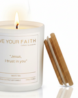 White candle with "Jesus I trust in You Prayer" on a white background