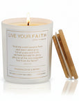 Candle with 'Live Your Faith' text and wooden lid on a white background