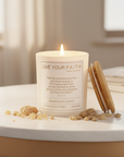 Candle with Bible verse John 1:14 surrounded by frankincense and myrrh on a blurred background