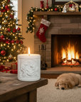 Nativity Candle with a dog  in front of a Christmas tree and fireplace.