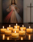 Nine small yellow beeswax candles on a home altar with an image of the divine mercy.