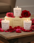 Candles with 'Live Your Faith' branding on a wooden surface with red and pink roses.