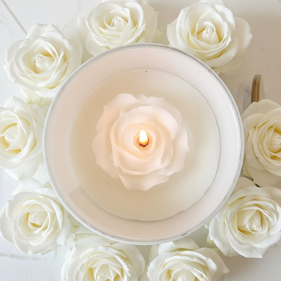 our lady of sorrows candle lit surrounded with roses