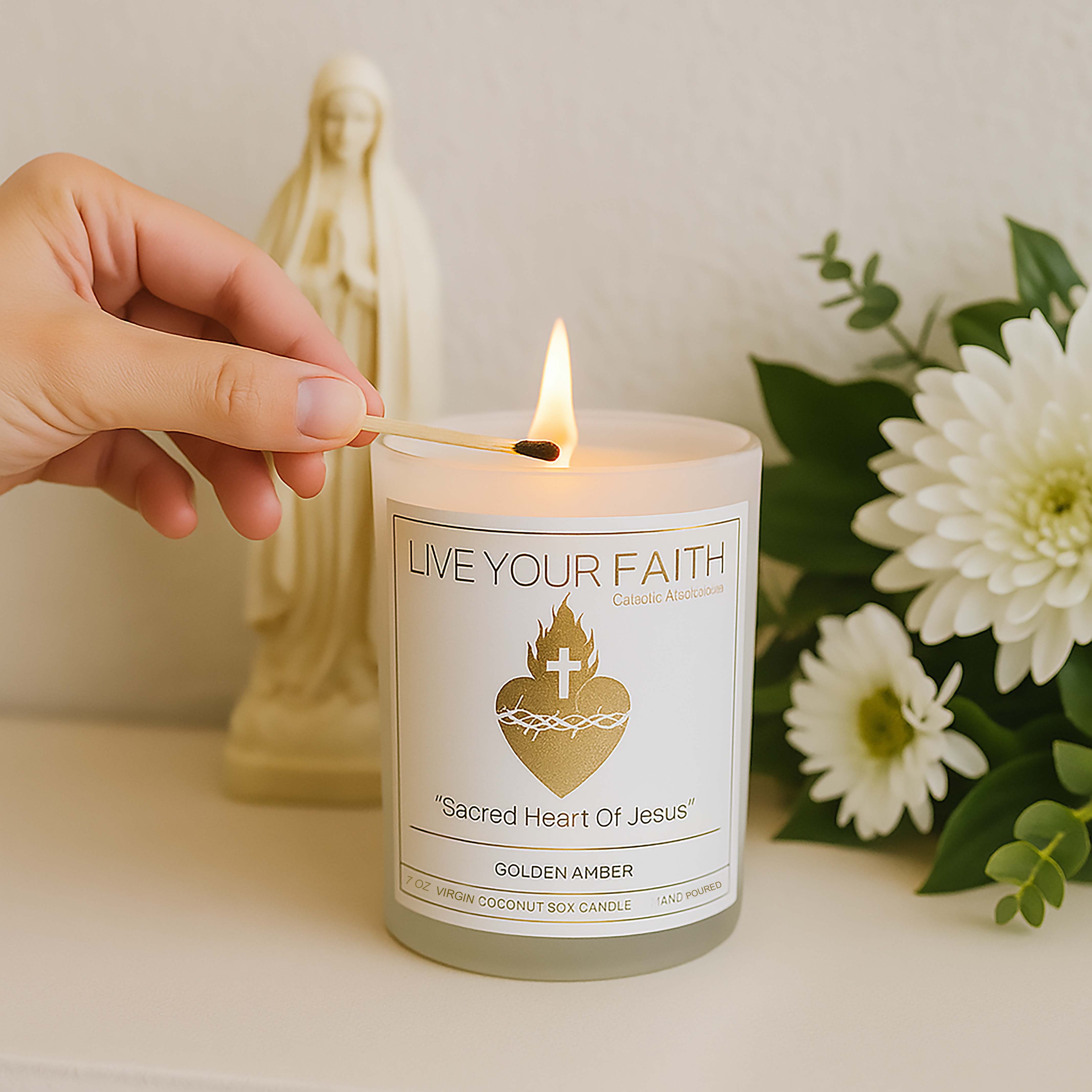 Sacred Heart Of Jesus Candle with flowers and a hand lighting it.