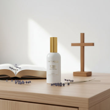 White spray bottle with gold cap on a white background
