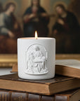 Candle with the image of Pieta on top of a book