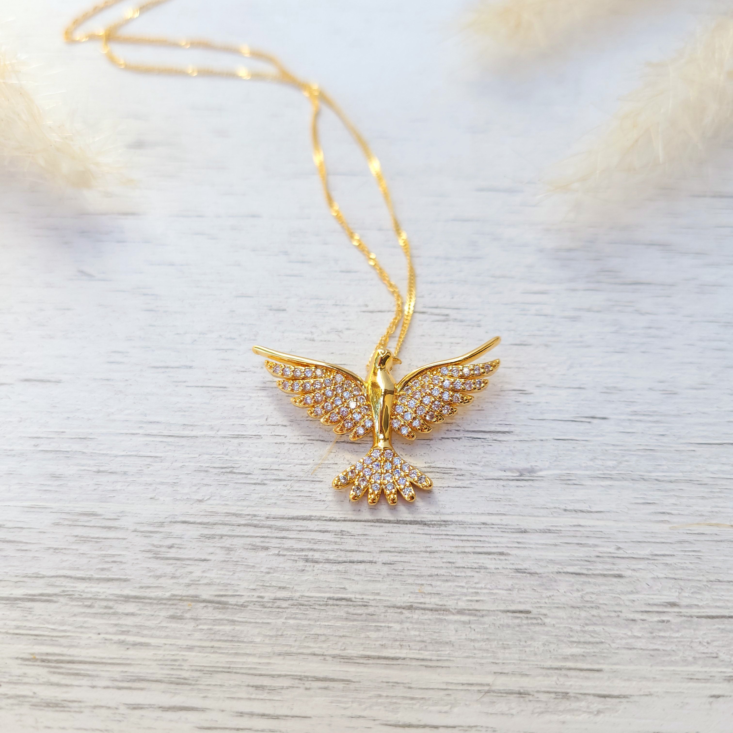 cubic zirconia dove necklace on a white surface