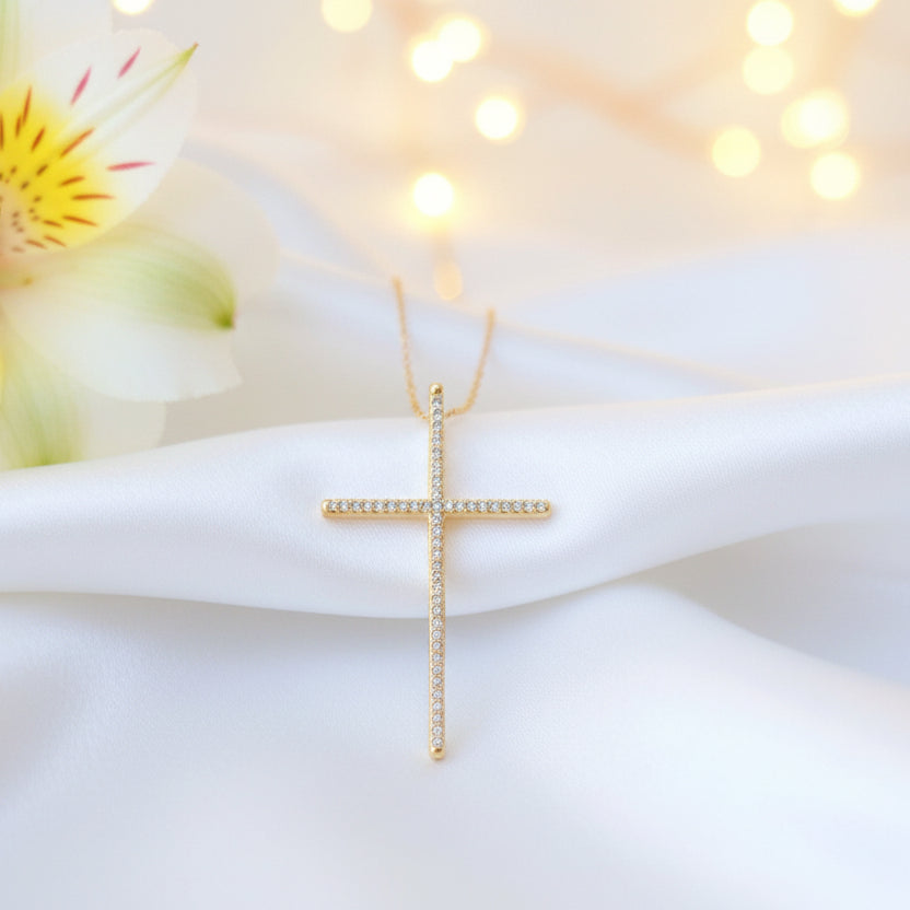 Gold Cross Necklace on a white satin fabric